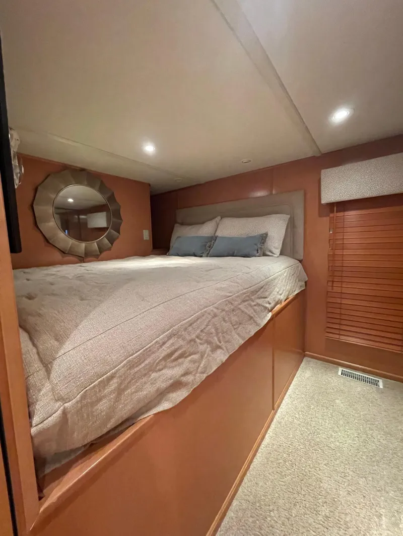 Slide: The Image of Cozy bedroom in a 2003 Sharpe 75' Houseboat with modern decor and ambient lighting. - 22