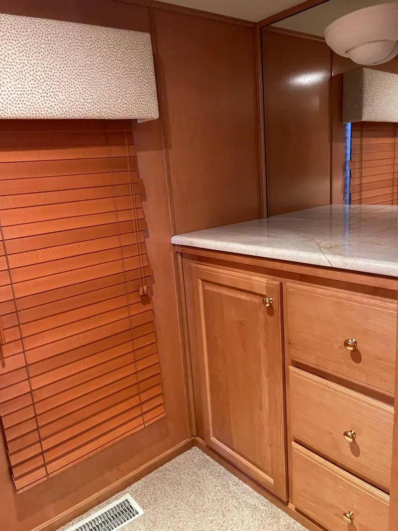 Slide: The Image of Interior of 2003 Sharpe 75' Houseboat with wooden cabinets and blinds. - 23