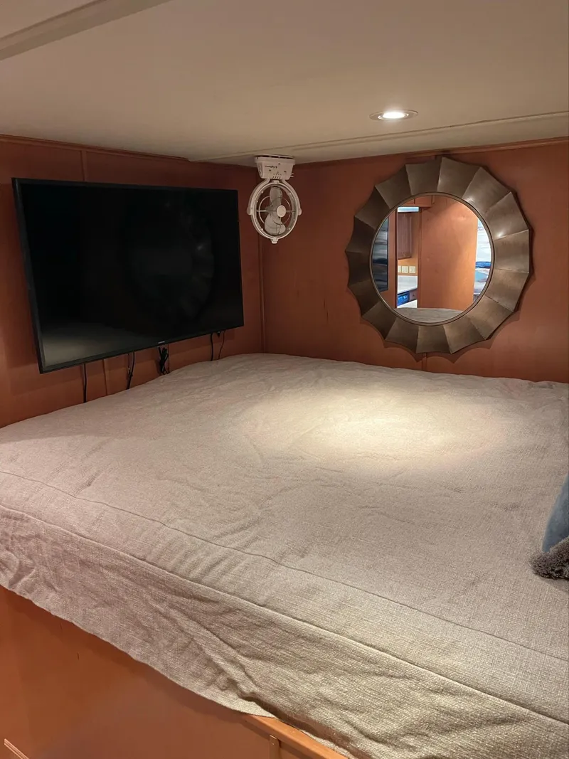 Slide: The Image of Cozy bedroom in 2003 Sharpe 75' Houseboat with TV and decorative mirror. - 24