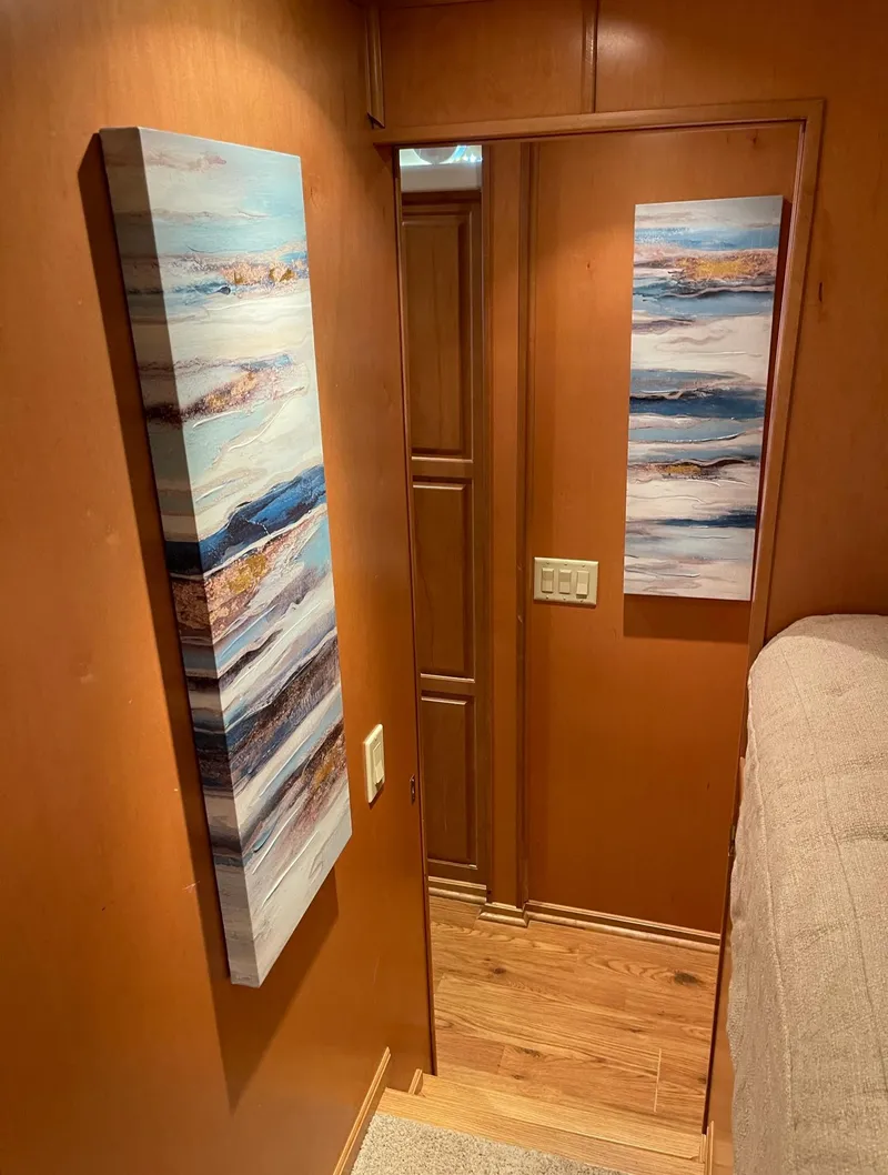 Slide: The Image of Interior hallway of a 2003 Sharpe 75' Houseboat with modern wall art. - 25