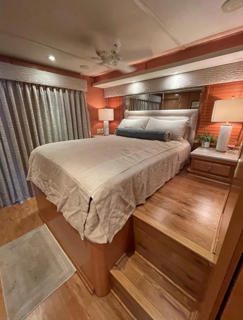 Slide: The Image of Luxurious bedroom in a 2003 Sharpe 75' Houseboat with wooden flooring and cozy lighting. - 27