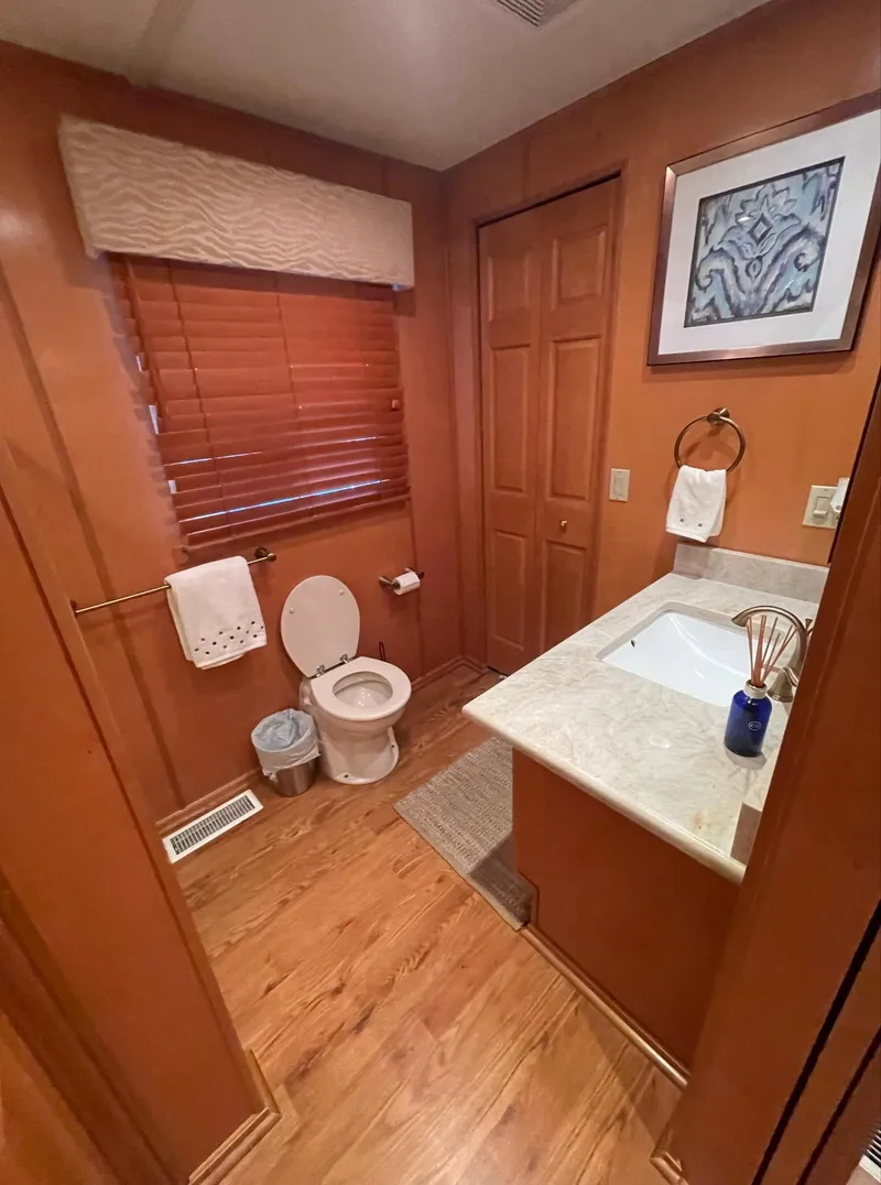 Slide: The Image of 2003 Sharpe 75' Houseboat bathroom with wooden decor and modern amenities. - 29