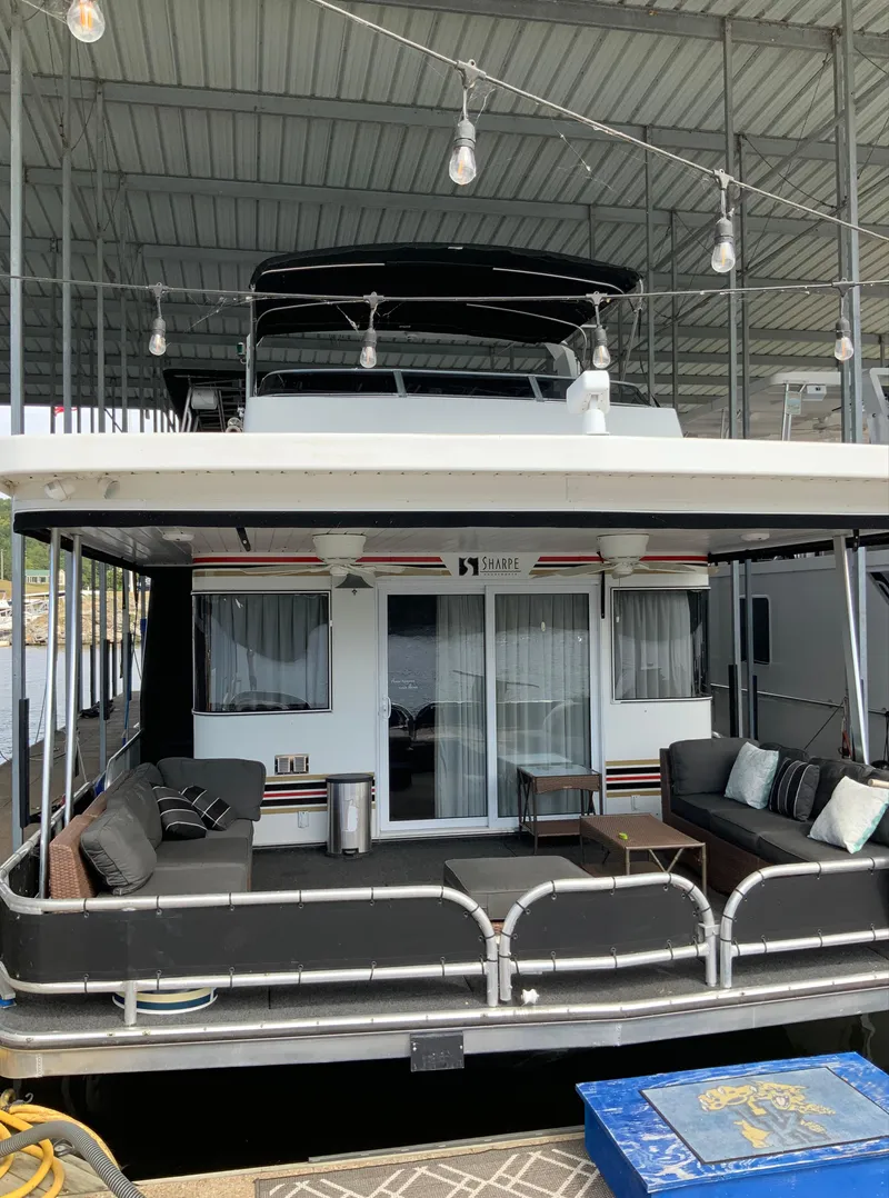 Slide: The Image of 2003 Sharpe 75' Houseboat docked with outdoor seating area. - 3