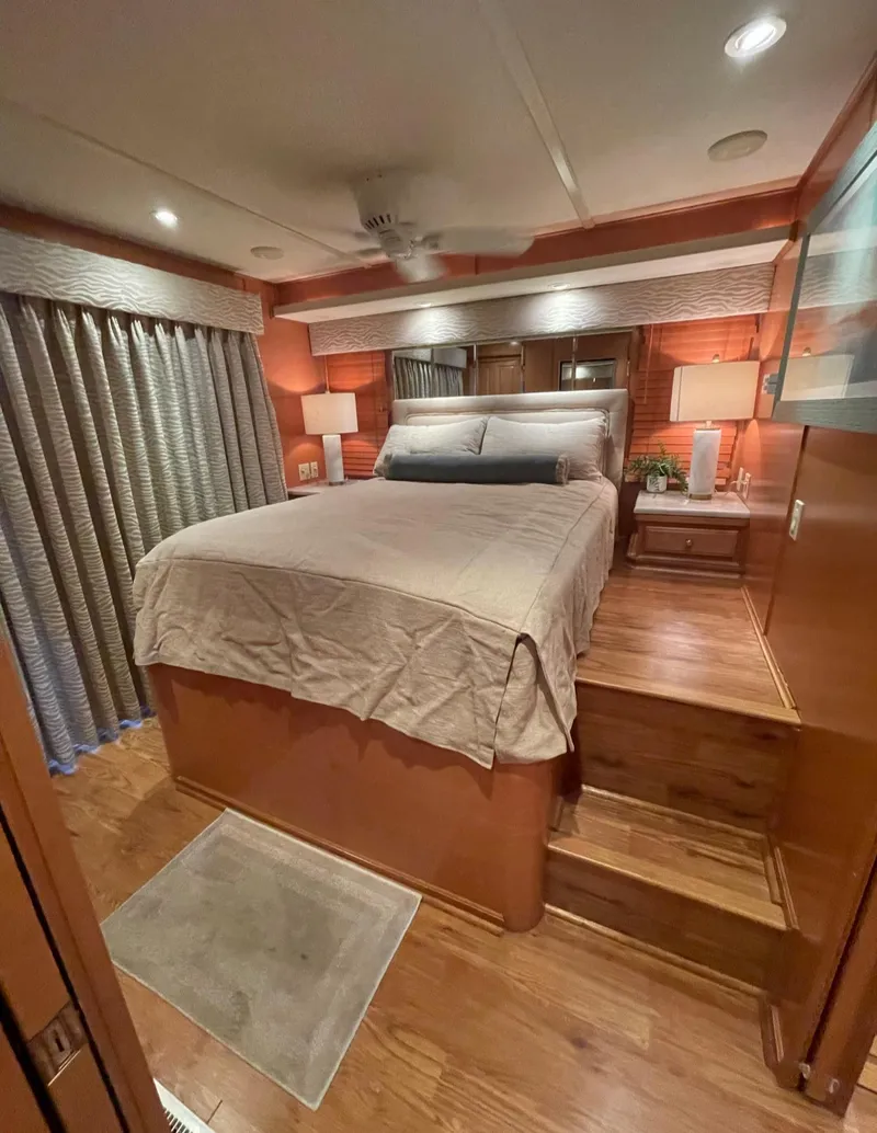 Slide: The Image of Cozy bedroom in a 2003 Sharpe 75' houseboat with wooden steps and ambient lighting. - 32