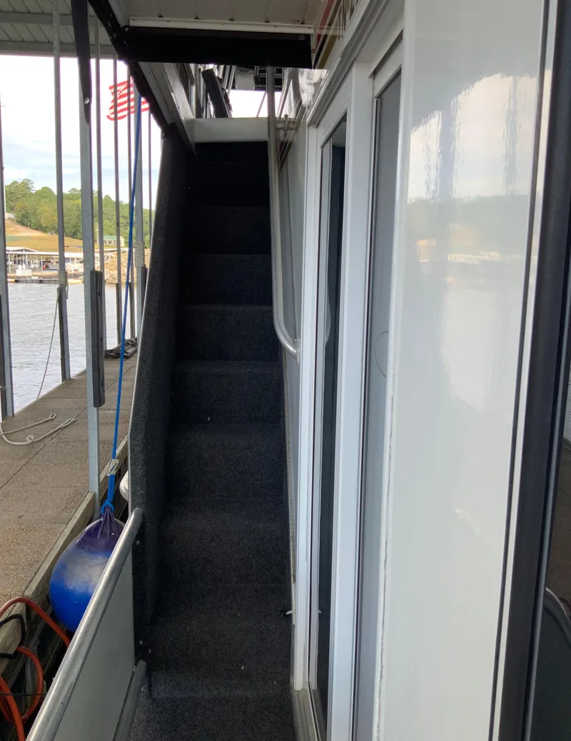 Slide: The Image of Side view of 2003 Sharpe 75' Houseboat with exterior stairs and dock. - 33