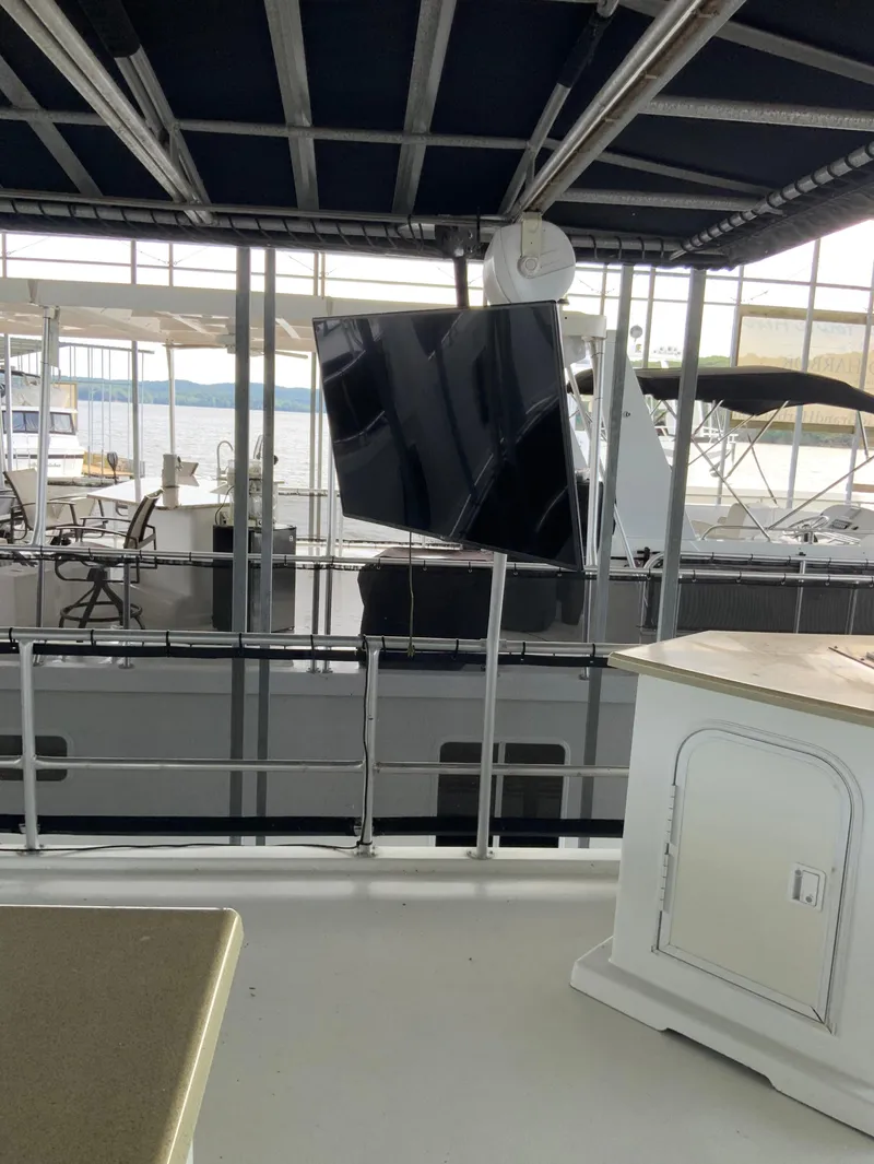 Slide: The Image of 2003 Sharpe 75' Houseboat with outdoor seating and lake view. - 38