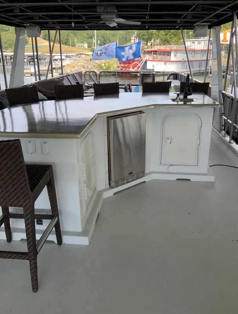 Slide: The Image of Outdoor bar area on a 2003 Sharpe 75' Houseboat with wicker chairs and marina view. - 39