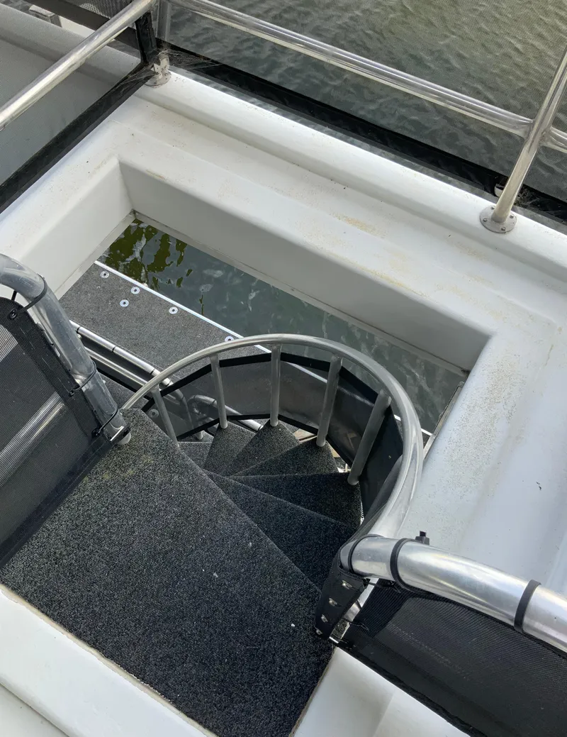 Slide: The Image of Spiral staircase on a 2003 Sharpe 75' Houseboat leading to the water. - 44