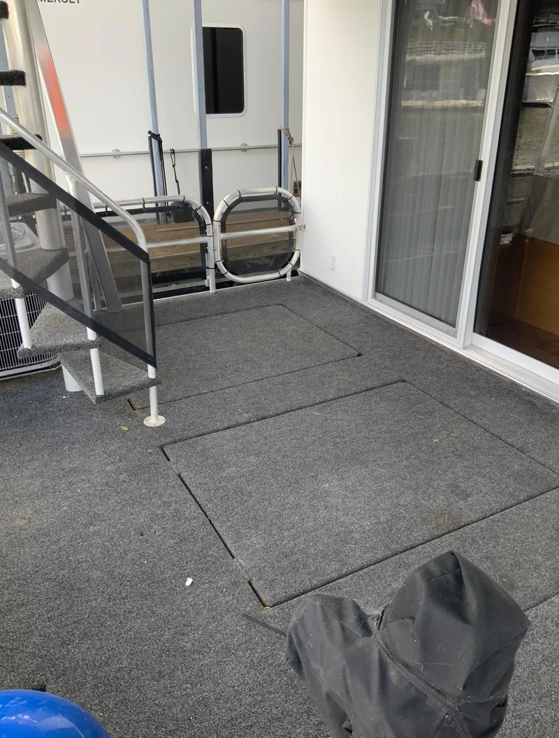 Slide: The Image of 2003 Sharpe 75' Houseboat deck with carpet and sliding glass door. - 48