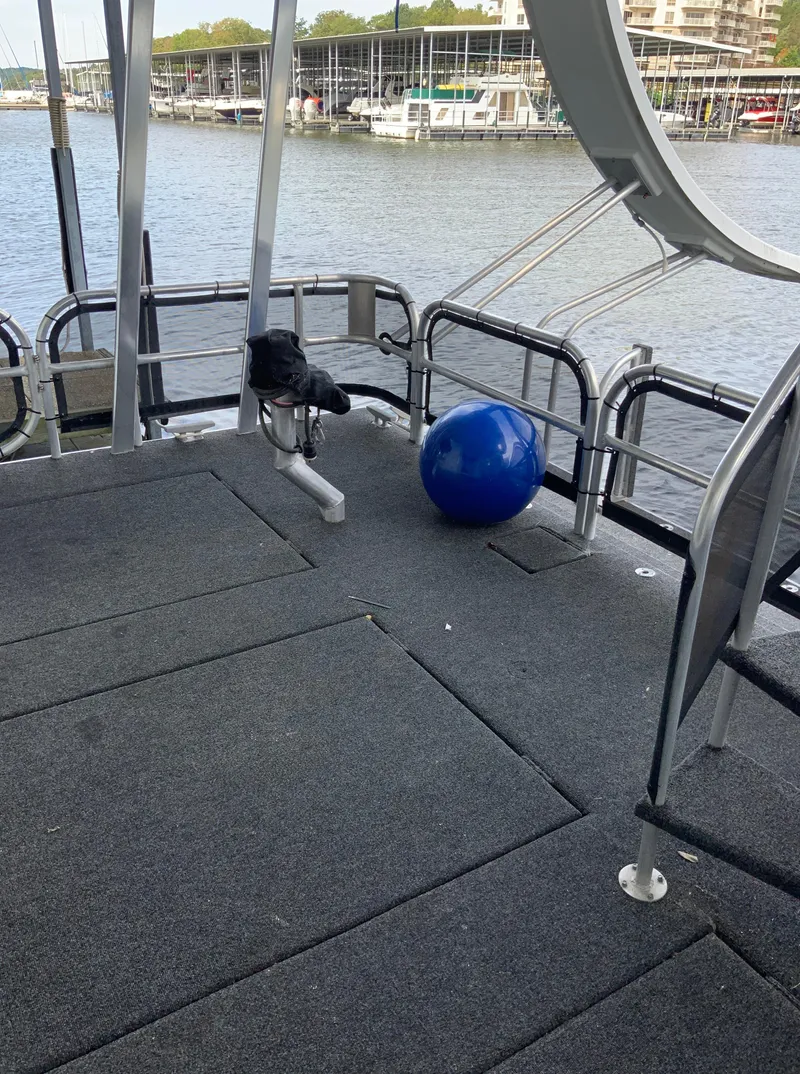 Slide: The Image of 2003 Sharpe 75' Houseboat deck with exercise ball, docked at marina. - 49