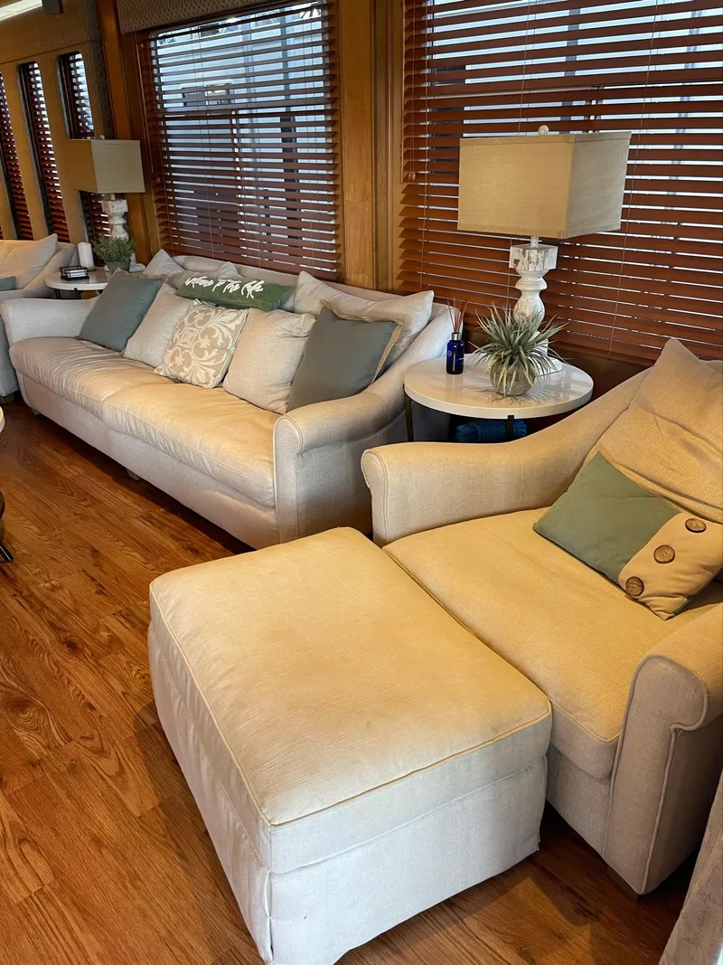Slide: The Image of Luxurious interior of a 2003 Sharpe 75' Houseboat with cozy seating and wooden blinds. - 5