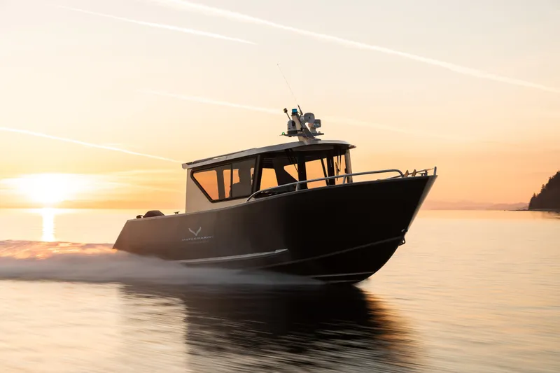 Slide: The Image of 2025 Jasper Marine Defender 22 boat cruising at sunset. - 14