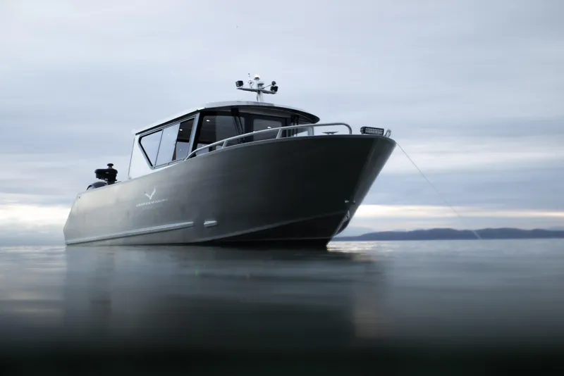Slide: The Image of 2025 Jasper Marine Defender 22 boat on calm water. - 3
