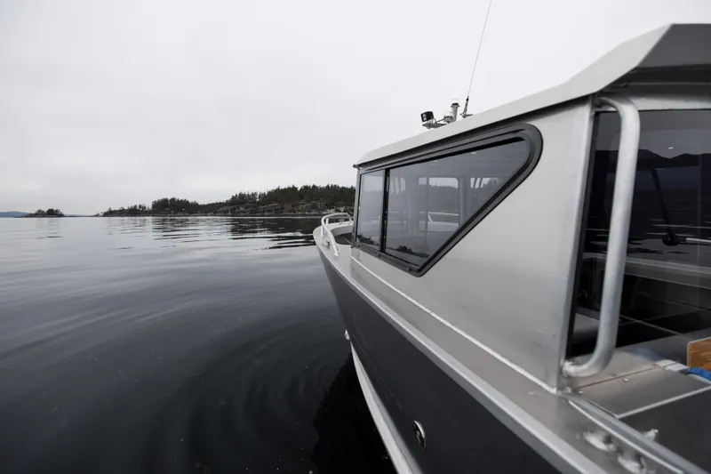 Slide: The Image of 2025 Jasper Marine Defender 22 boat on calm waters. - 8