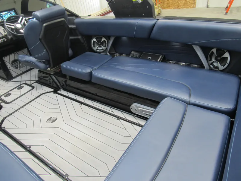 Slide: The Image of 2019 Malibu Wakesetter 24 MXZ interior with blue leather seats and modern dashboard. - 10