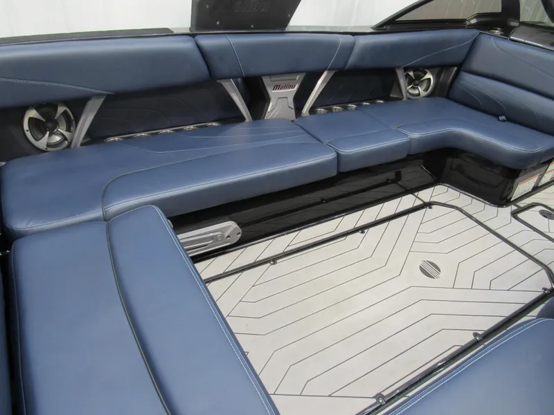 Slide: The Image of 2019 Malibu Wakesetter 24 MXZ interior with blue leather seating and modern design. - 11