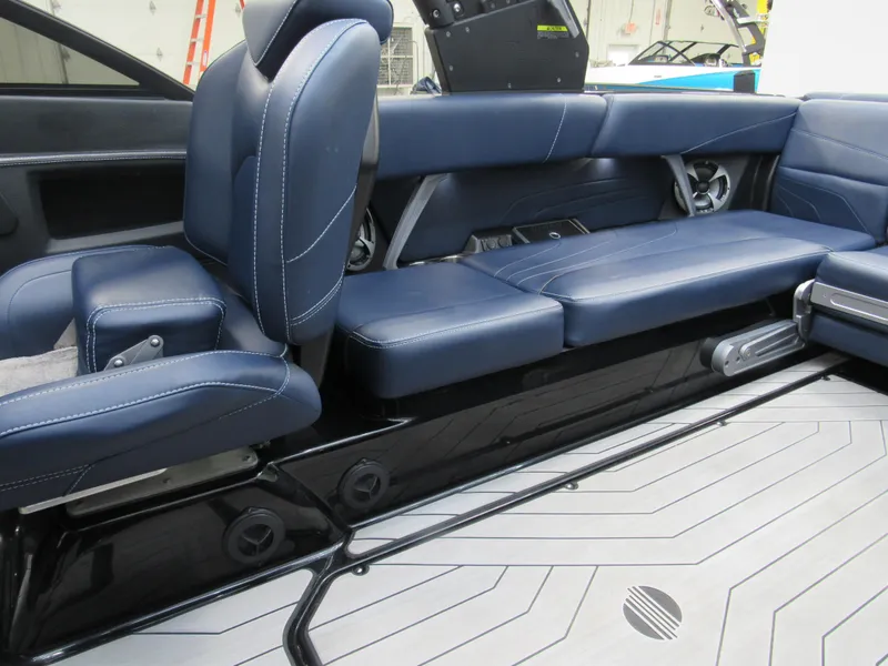 Slide: The Image of 2019 Malibu Wakesetter 24 MXZ interior with blue leather seating. - 12