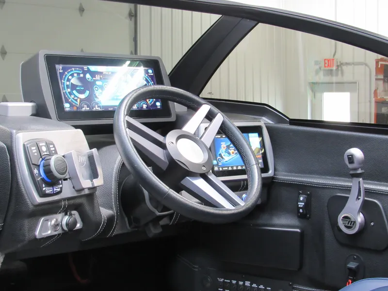 Slide: The Image of 2019 Malibu Wakesetter 24 MXZ dashboard with advanced controls and touchscreen displays. - 13