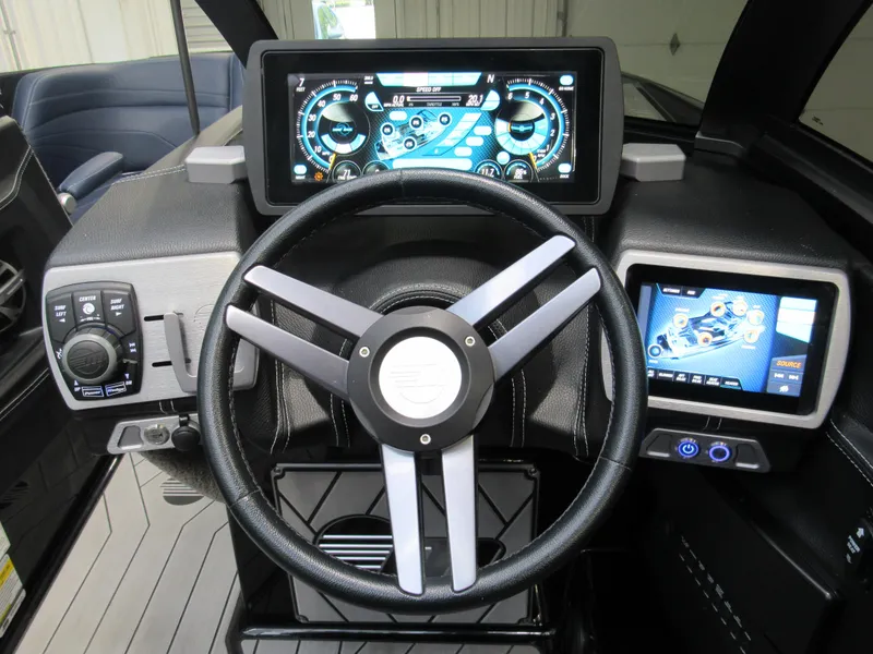 Slide: The Image of 2019 Malibu Wakesetter 24 MXZ dashboard with advanced touchscreen controls and steering wheel. - 14