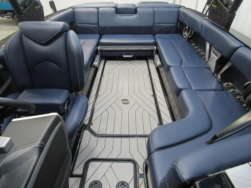 Slide: The Image of 2019 Malibu Wakesetter 24 MXZ interior with blue leather seating and spacious layout. - 16
