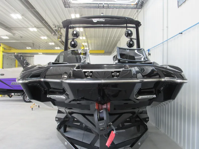 Slide: The Image of 2019 Malibu Wakesetter 24 MXZ boat in a showroom. - 2