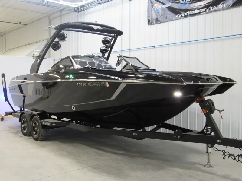 Slide: The Image of 2019 Malibu Wakesetter 24 MXZ black boat on trailer in indoor storage. - 5
