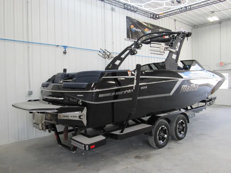 Slide: The Image of 2019 Malibu Wakesetter 24 MXZ boat on trailer in indoor storage. - 6