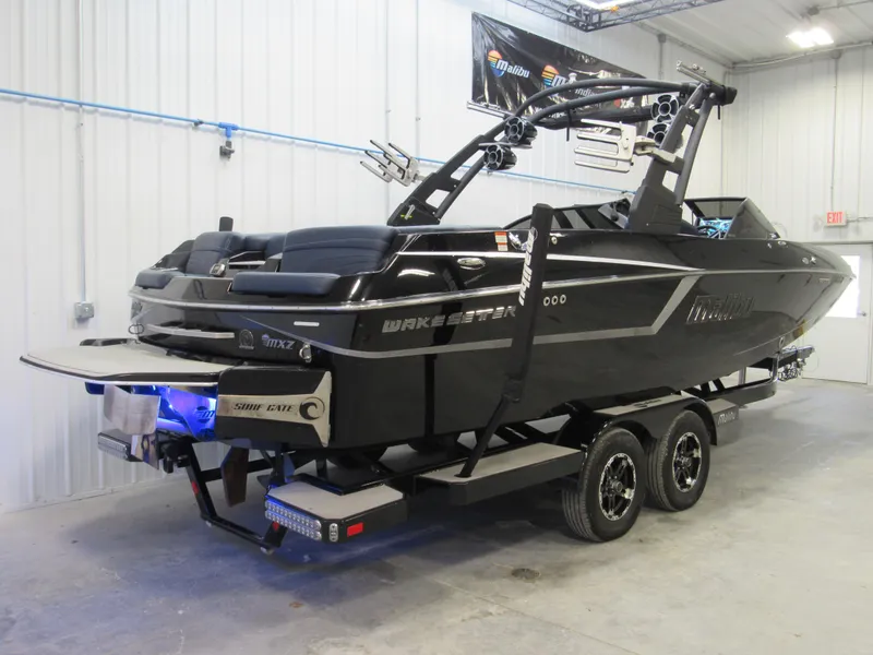 Slide: The Image of 2019 Malibu Wakesetter 24 MXZ boat on trailer in indoor storage. - 7