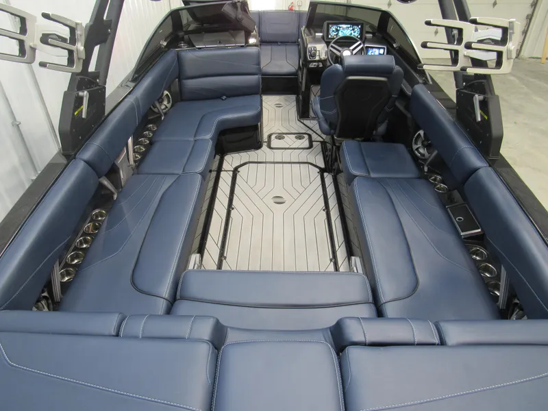 Slide: The Image of 2019 Malibu Wakesetter 24 MXZ interior with blue leather seating and modern dashboard. - 9