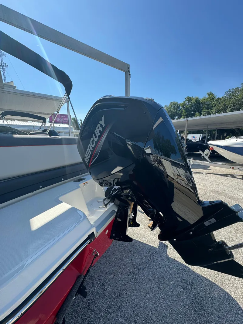 Slide: The Image of 2024 Bayliner Element M19 with Mercury outboard motor, docked in a marina. - 11