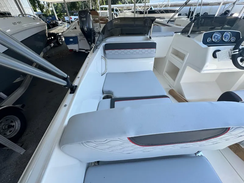 Slide: The Image of 2024 Bayliner Element M19 boat interior with seating and dashboard. - 9