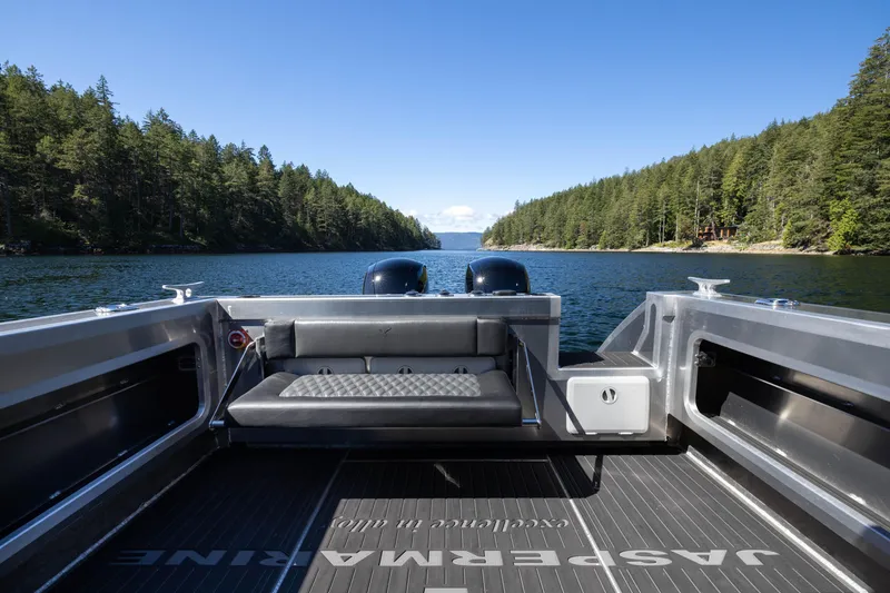 Slide: The Image of Jasper Marine Defender 22 boat on a serene lake surrounded by lush forests, 2025 model. - 25