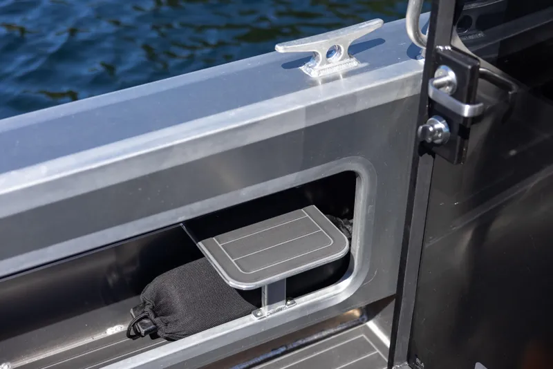 Slide: The Image of Jasper Marine Defender 22 (2025) boat interior detail with storage compartment and cleat. - 28