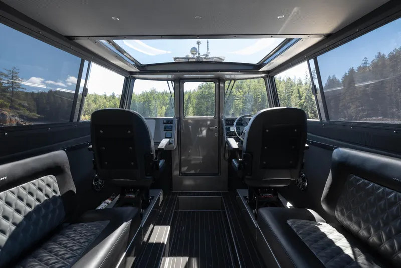 Slide: The Image of Interior of 2025 Jasper Marine Defender 22 boat with panoramic windows and luxurious seating. - 31
