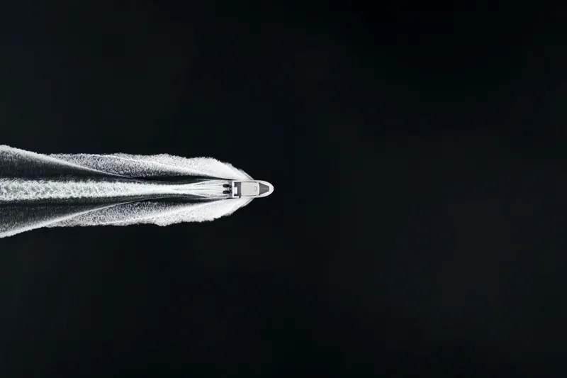 Slide: The Image of Aerial view of Jasper Marine Defender 22 boat cruising on dark water, 2025 model. - 39