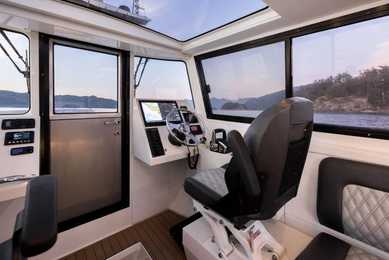 Slide: The Image of Interior of 2025 Jasper Marine Defender 22 boat, featuring modern navigation controls and seating. - 44