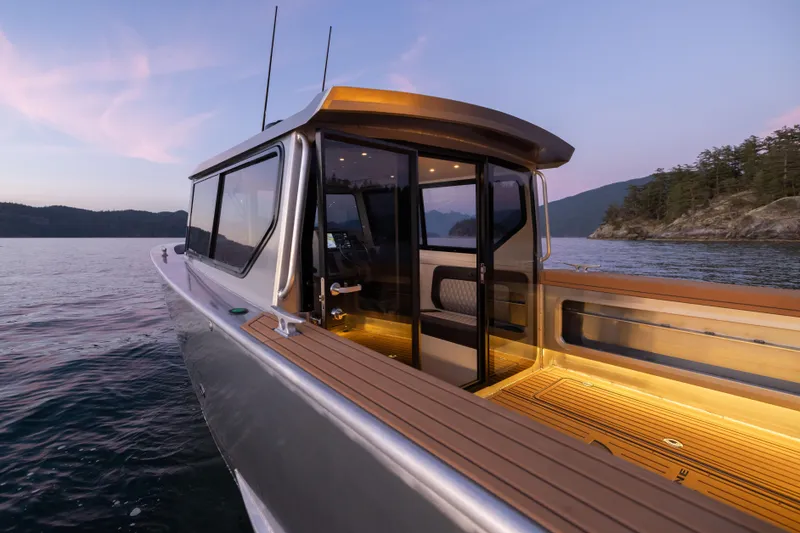 Slide: The Image of Jasper Marine Defender 22 boat, 2025 model, on serene water at sunset. - 48