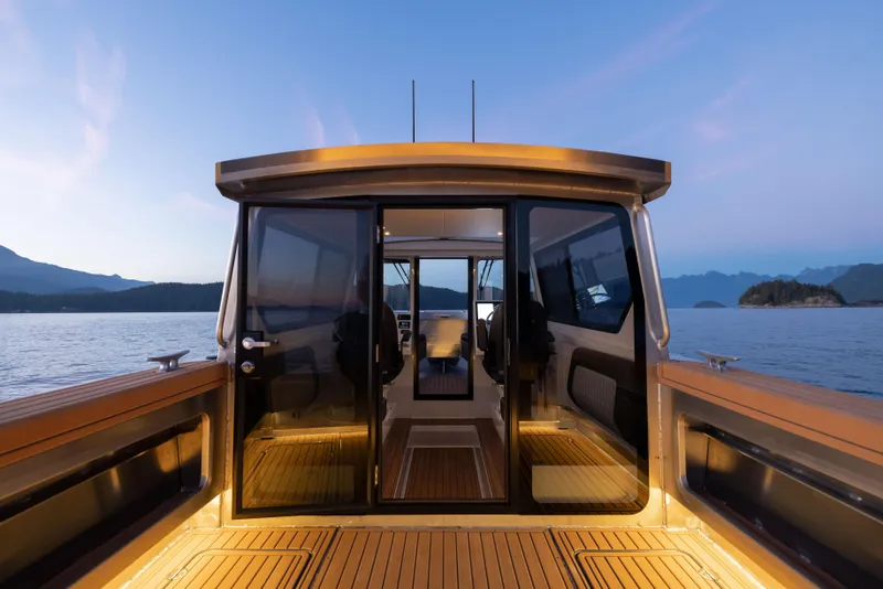 Slide: The Image of 2025 Jasper Marine Defender 22 boat interior with scenic ocean view at sunset. - 49