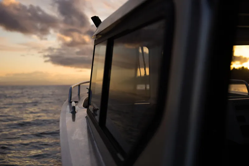 Slide: The Image of Jasper Marine Defender 22 boat at sunset on the ocean, 2025 model. - 5