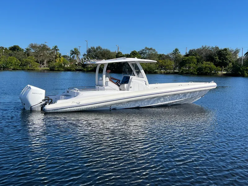 The Image of 2024 Airship 340 boat on a calm lake with a clear blue sky. - 1