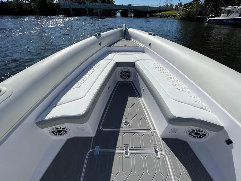 Slide: The Image of 2024 Airship 340 boat interior with cushioned seating and speakers on a sunny day. - 15