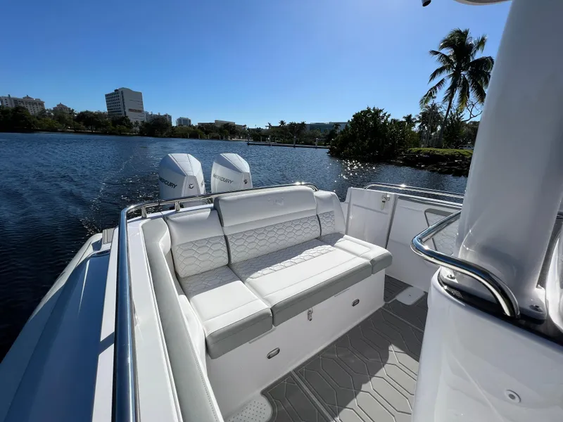 Slide: The Image of 2024 Airship 340 boat with white seating and twin engines on a sunny day. - 9