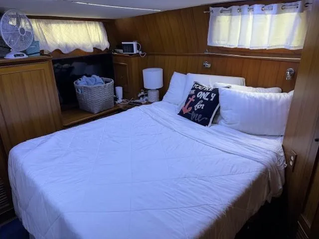 Slide: The Image of 1989 Jefferson Motoryacht bedroom with cozy bed and wooden interior. - 19