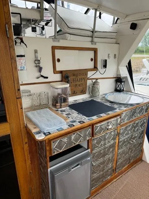 Slide: The Image of 1989 Jefferson Motoryacht kitchen area with metallic cabinets, countertop decor, and small appliances. - 6