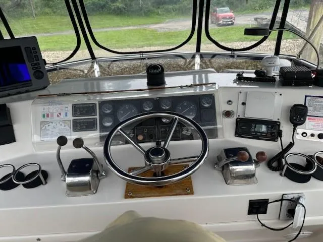 Slide: The Image of 1989 Jefferson Motoryacht helm with steering wheel, controls, and navigation equipment. - 9