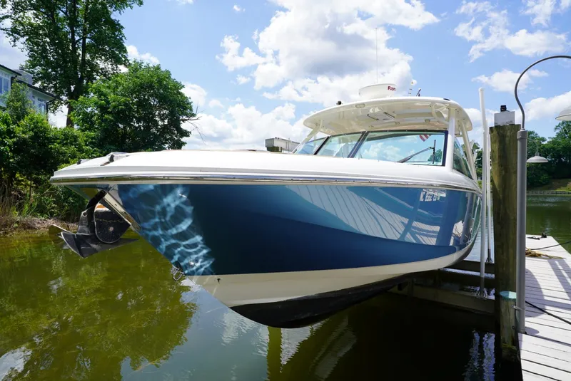 The Image of 2016 Boston Whaler 320 Vantage boat docked on a sunny day. - 0