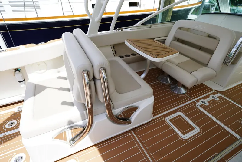 Slide: The Image of 2016 Boston Whaler 320 Vantage boat interior with seating and table. - 14
