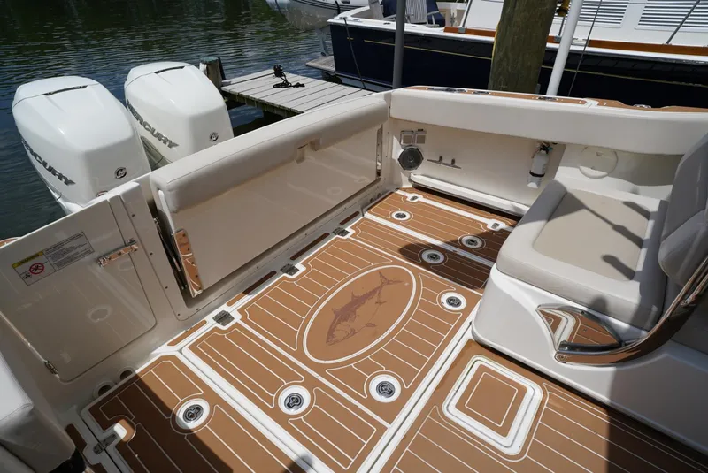 Slide: The Image of 2016 Boston Whaler 320 Vantage boat deck with twin outboard engines. - 17