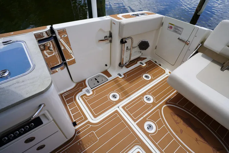 Slide: The Image of 2016 Boston Whaler 320 Vantage boat deck with teak flooring and seating area. - 19