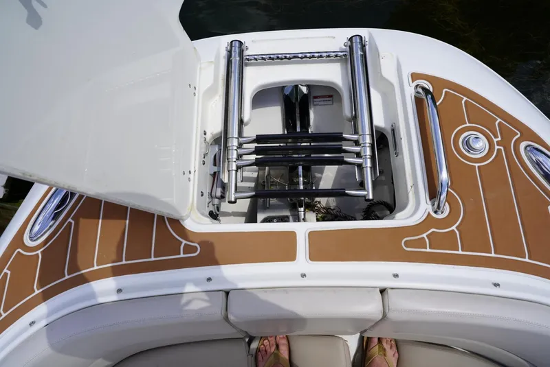 Slide: The Image of Boston Whaler 320 Vantage 2016 boat with open storage compartment and ladder. - 2